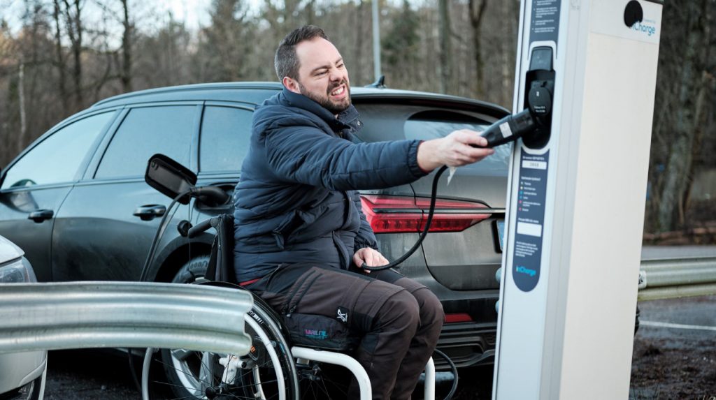 British WAV Supplier | Lewis Reed Group | Man in wheelchair with electric charger